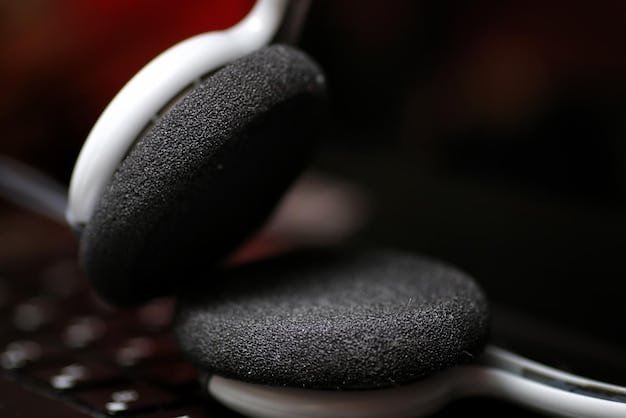 A close-up shot of the ear cup of the Bose wireless headphones, highlighting the noise-canceling microphones and the comfortable padding.